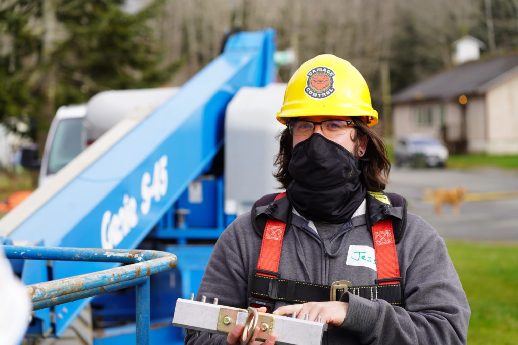worker installing solar panels at the Quinault Indian Nation.