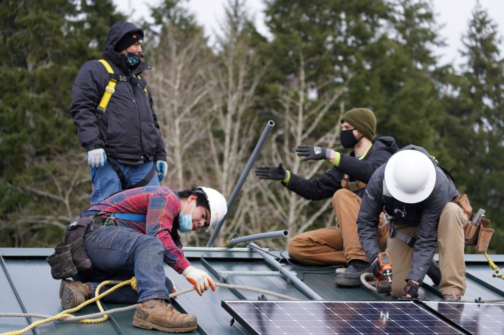 Workers installing solar panels