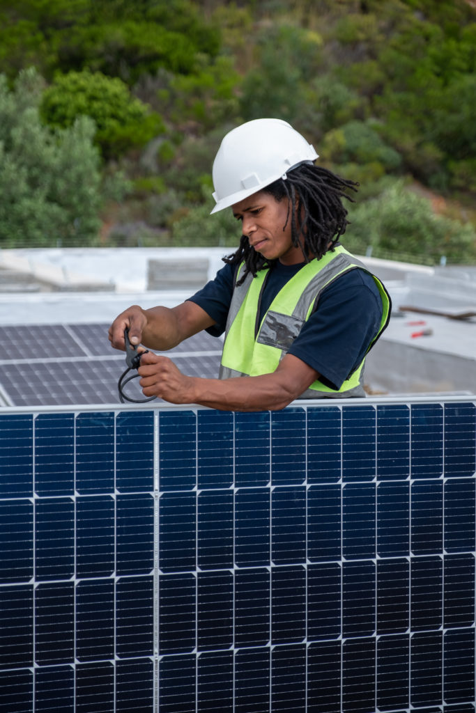 Worker installing solar panels.