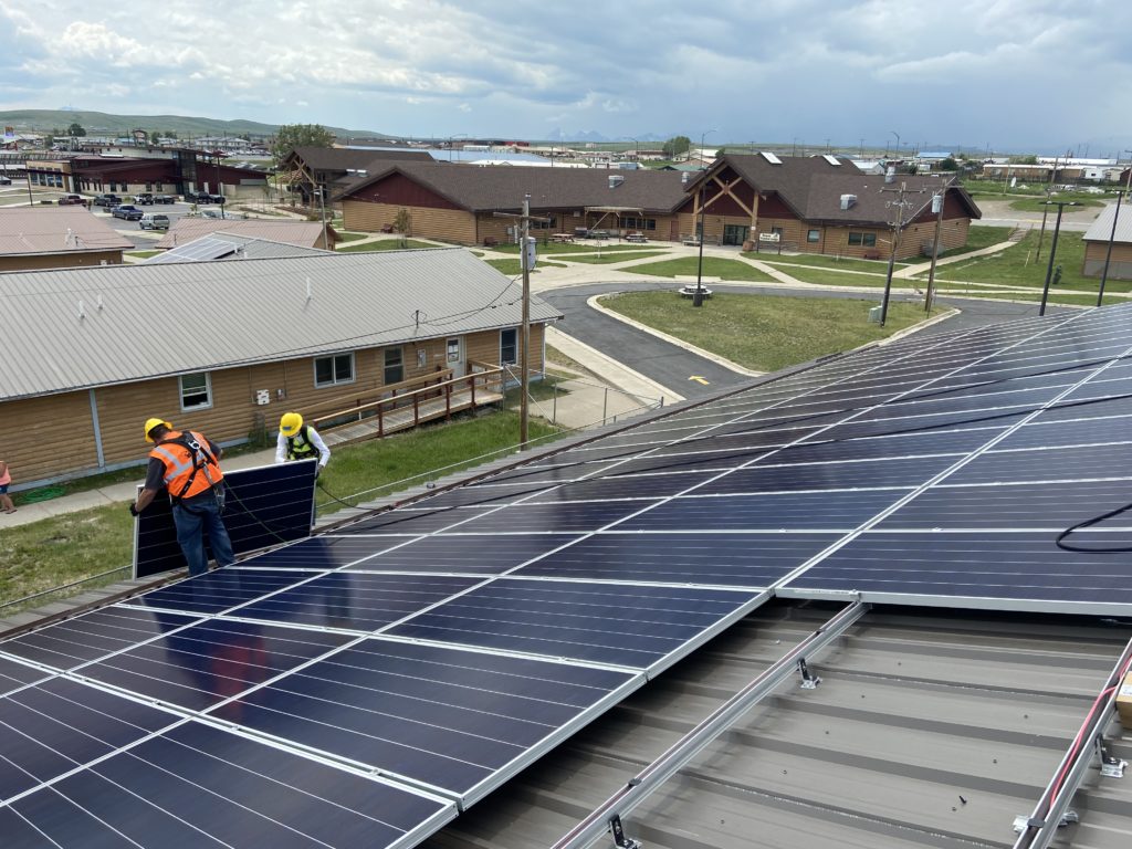 photo of solar panel field in blackfeet nation workers