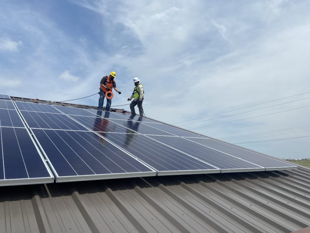 photo of solar panel field in blackfeet nation workers
